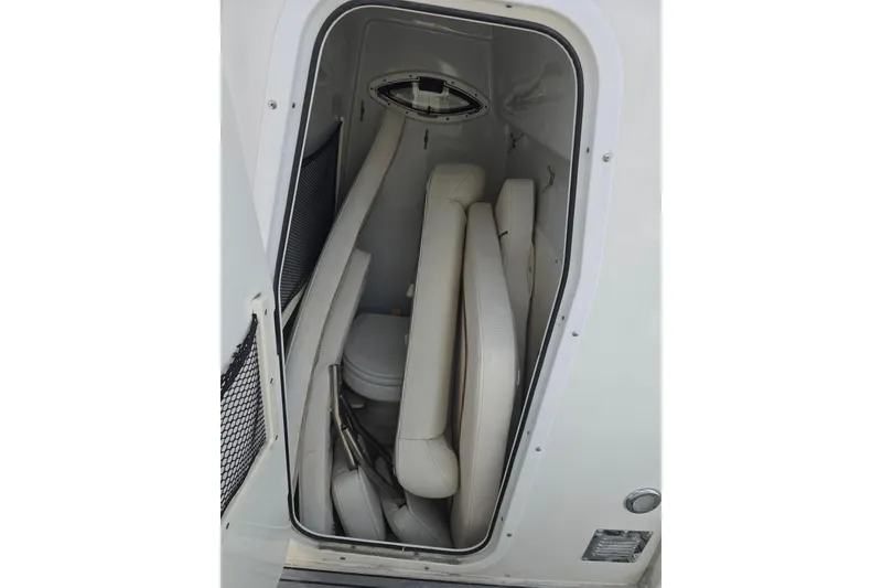 Slide: The Image of 2019 Sea Hunt Gamefish 25 storage compartment with cushions and a small window. - 28