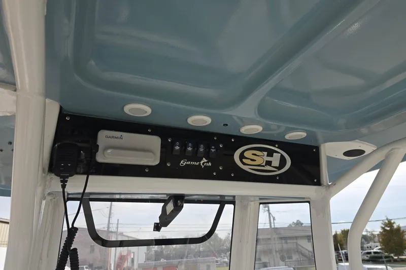 Slide: The Image of 2019 Sea Hunt Gamefish 25 boat console with Garmin electronics and SH logo. - 29