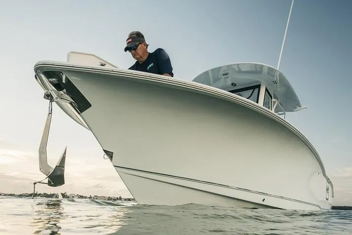 Slide: The Image of 2019 Sea Hunt Gamefish 25 with dual Yamaha 150 engines, parked outdoors. - 3