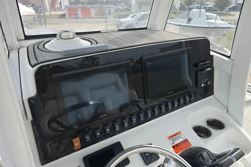 Slide: The Image of 2019 Sea Hunt Gamefish 25 helm with dual Garmin displays and control panel. - 31