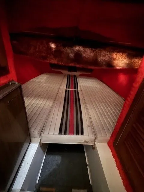 Slide: The Image of Interior of a 1983 Mirage 314 SZ boat with striped upholstery. - 10