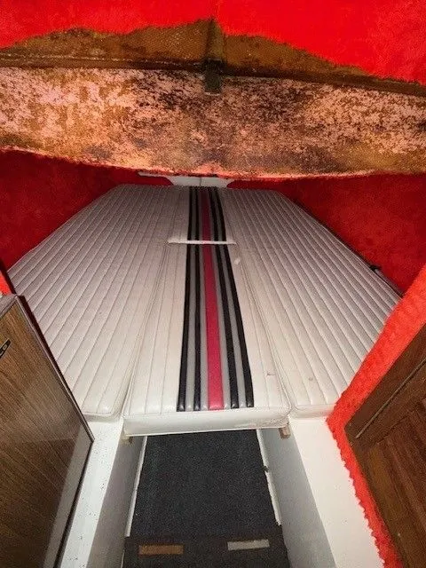 Slide: The Image of Interior of a 1983 Mirage 314 SZ boat with striped upholstery. - 11