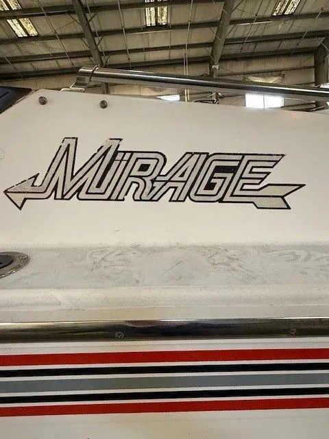 Slide: The Image of 1983 Mirage 314 SZ boat with distinctive logo in warehouse. - 12