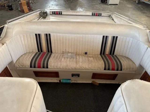 Slide: The Image of Interior of a 1983 Mirage 314 SZ boat with striped seating. - 3