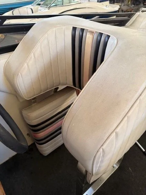 Slide: The Image of Interior of a 1983 Mirage 314 SZ boat with striped seats. - 5