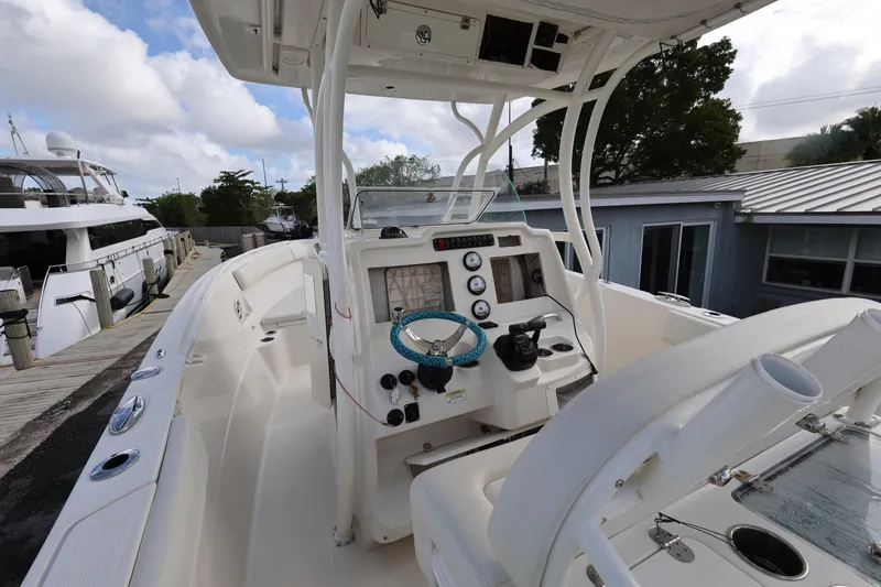 Slide: The Image of 2014 Sailfish 270 CC boat interior with steering wheel and control panel. - 10