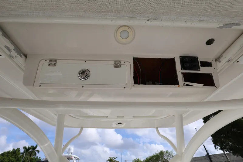 Slide: The Image of 2014 Sailfish 270 CC boat interior ceiling with storage compartment and wiring. - 12