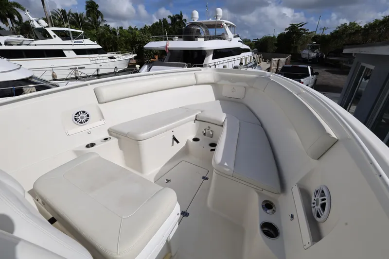 Slide: The Image of 2014 Sailfish 270 CC boat interior with white seating and cup holders. - 14