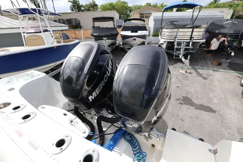 Slide: The Image of 2014 Sailfish 270 CC boat with dual Mercury outboard engines in a marina setting. - 22