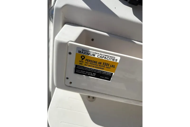 Slide: The Image of 2024 Key West 239 FS boat capacity label, maximum 9 persons or 1301 lbs. - 10