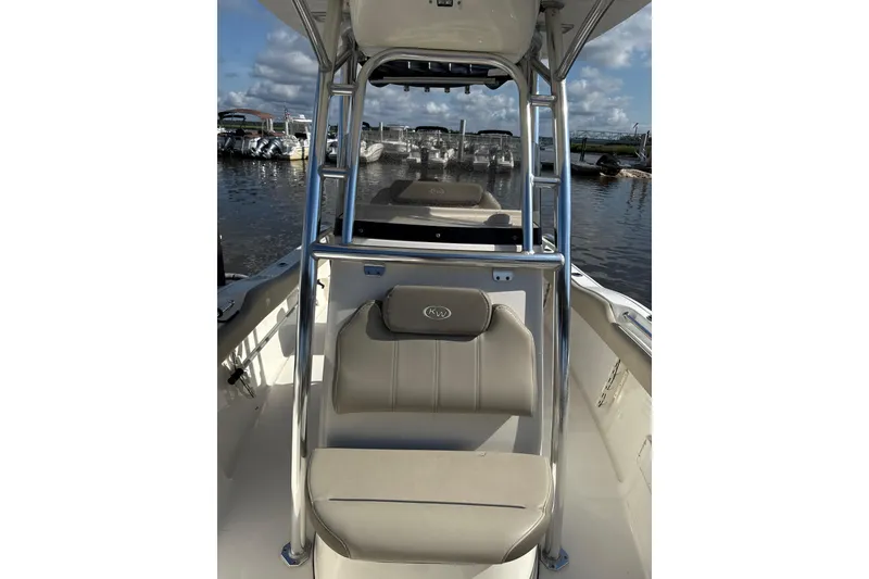 Slide: The Image of 2024 Key West 239 FS boat interior with seating and console, docked at marina. - 5
