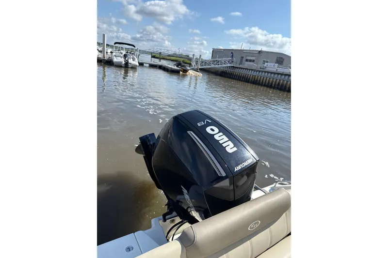 Slide: The Image of 2024 Key West 239 FS boat with Mercury outboard engine at a marina. - 9