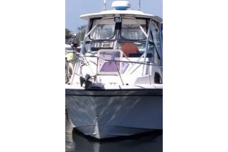 Slide: The Image of 2001 Grady-White Sailfish 282 boat docked, front view, with clear skies. - 1