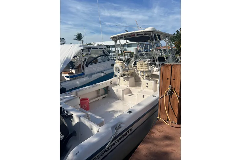Slide: The Image of 2001 Grady-White Sailfish 282 boat docked, featuring spacious deck and seating. - 3