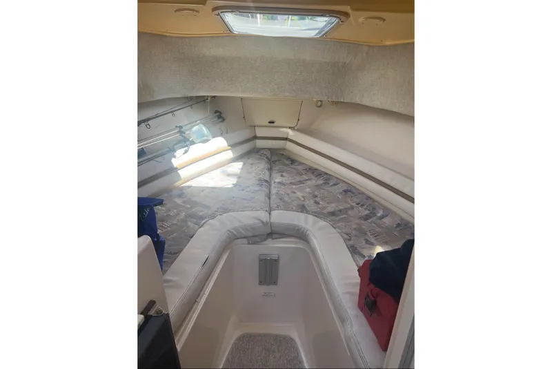 Slide: The Image of 2001 Grady-White Sailfish 282 cabin interior with cushioned seating and overhead hatch. - 6