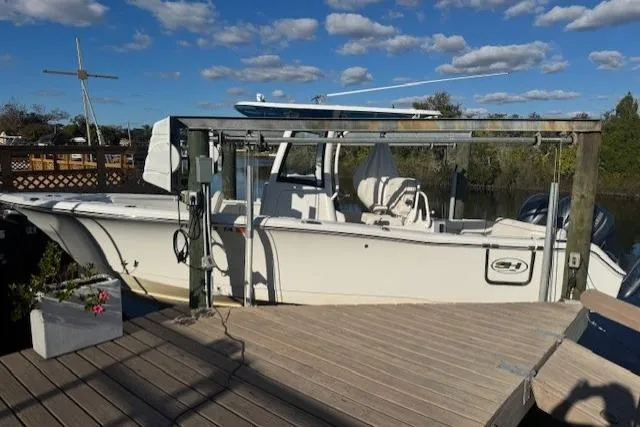 The Image of 2021 Sea Hunt Ultra 265 SE boat docked under a clear blue sky. - 0