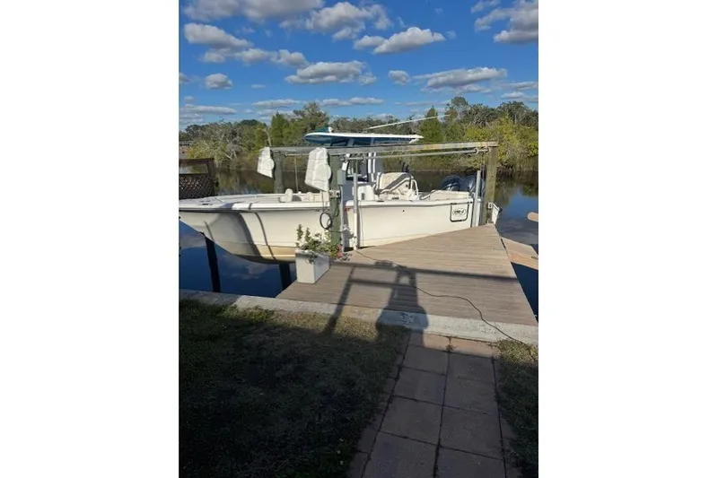 Slide: The Image of 2021 Sea Hunt Ultra 265 SE boat docked on a sunny day. - 1
