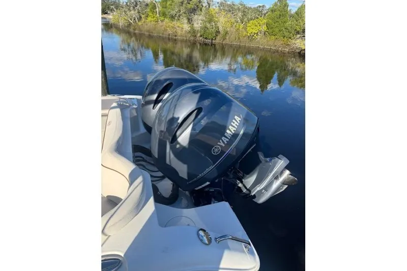 Slide: The Image of 2021 Sea Hunt Ultra 265 SE with Yamaha engines on a calm river. - 2