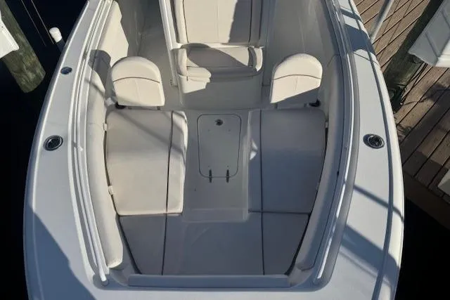Slide: The Image of 2021 Sea Hunt Ultra 265 SE boat interior with cushioned seating and storage. - 3