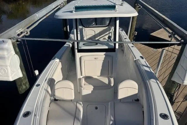 Slide: The Image of 2021 Sea Hunt Ultra 265 SE boat docked, showcasing spacious seating and sleek design. - 4