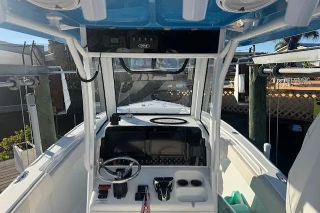 Slide: The Image of 2021 Sea Hunt Ultra 265 SE boat cockpit with steering wheel and control panel. - 5
