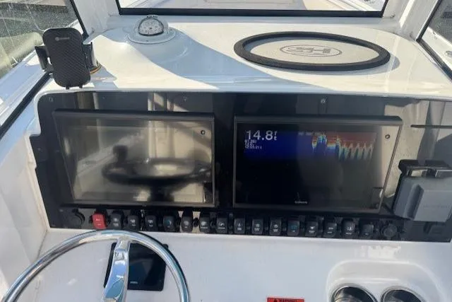 Slide: The Image of 2021 Sea Hunt Ultra 265 SE dashboard with navigation screens and controls. - 6