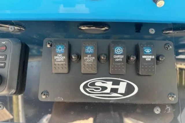 Slide: The Image of Control panel of a 2021 Sea Hunt Ultra 265 SE boat with light switches. - 8