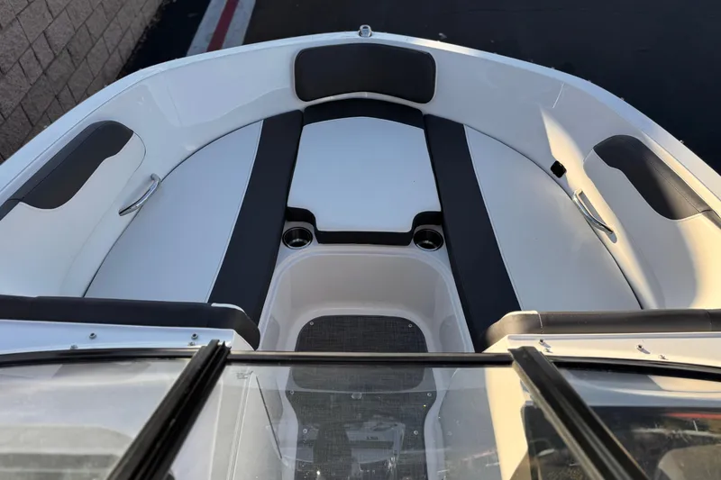 Slide: The Image of 2022 Bayliner VR5 Bowrider I/O boat interior with cushioned seating and cup holders. - 10