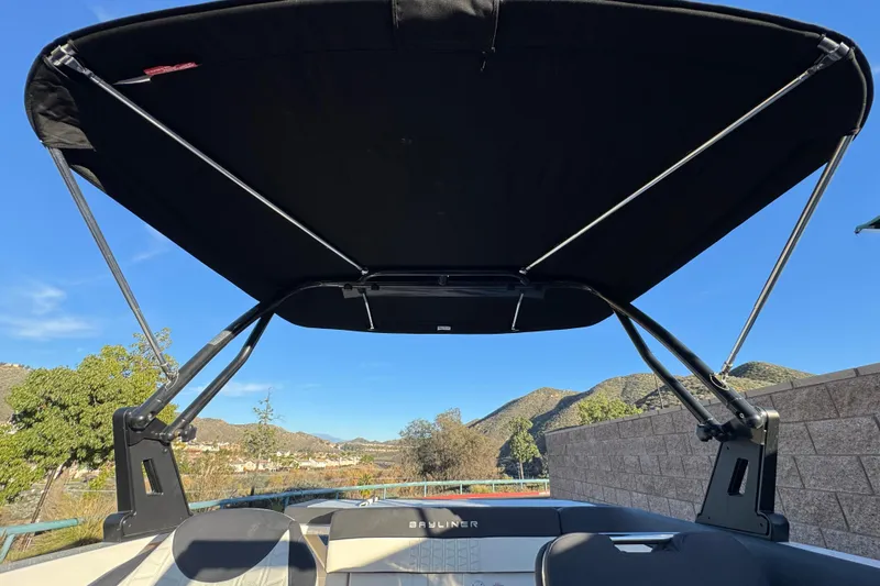 Slide: The Image of 2022 Bayliner VR5 Bowrider I/O with bimini top, scenic mountain backdrop. - 13