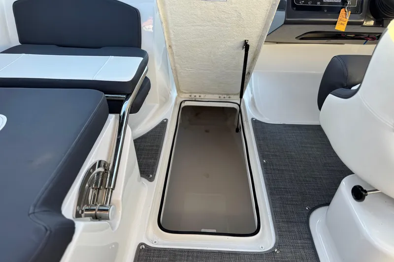 Slide: The Image of 2022 Bayliner VR5 Bowrider I/O interior with open storage compartment and seating. - 21