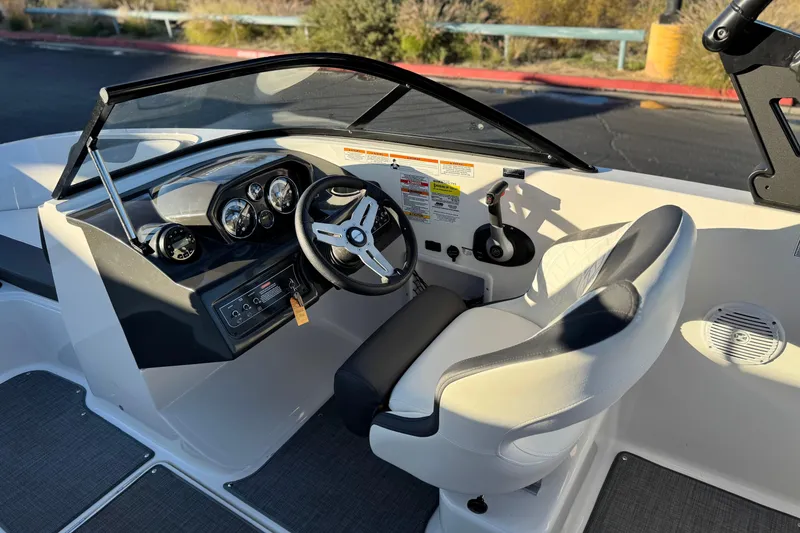 Slide: The Image of 2022 Bayliner VR5 Bowrider I/O cockpit with steering wheel and control panel. - 22