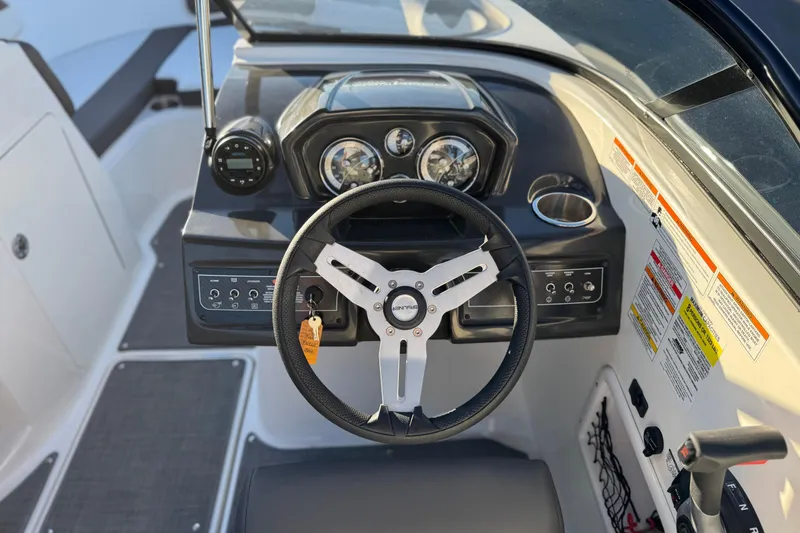 Slide: The Image of 2022 Bayliner VR5 Bowrider I/O dashboard with steering wheel and control panel. - 23