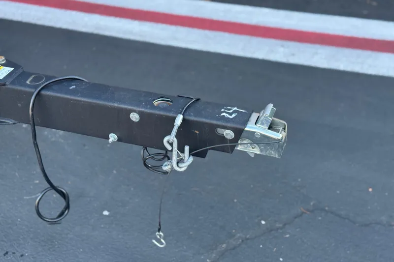 Slide: The Image of Trailer hitch of a 2022 Bayliner VR5 Bowrider I/O on asphalt. - 26
