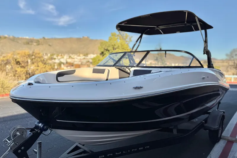 Slide: The Image of 2022 Bayliner VR5 Bowrider I/O boat on trailer, parked outdoors. - 3
