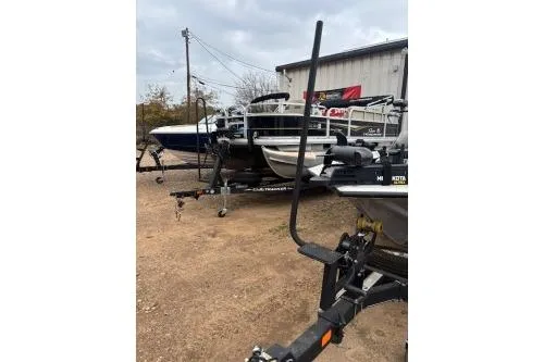 Slide: The Image of 2023 Tracker Pro Team 195 TXW Tournament Edition boat on trailer, parked outdoors. - 17