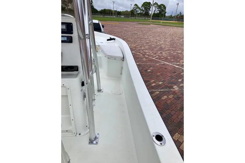 Slide: The Image of 2007 Coastal Bay 2310 boat interior with white deck and chrome railings. - 19