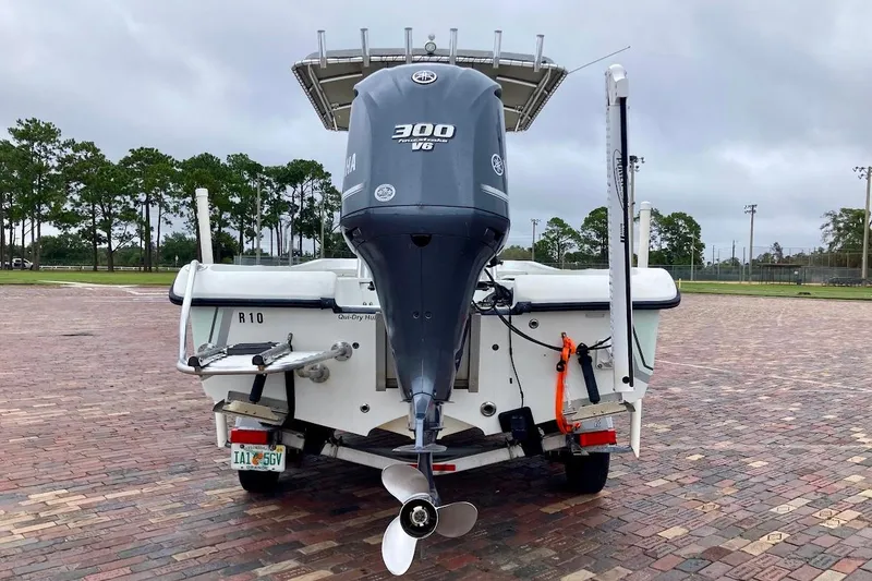 Slide: The Image of 2007 Coastal Bay 2310 boat with Yamaha 300 V6 engine on a brick-paved surface. - 2