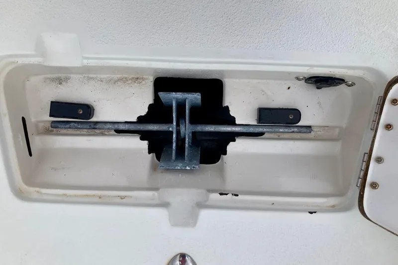 Slide: The Image of Compartment of 2007 Coastal Bay 2310 boat with metal rod and latch mechanism. - 28