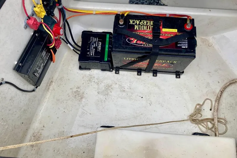 Slide: The Image of Battery setup in a 2007 Coastal Bay 2310 boat, featuring wiring and connections. - 30