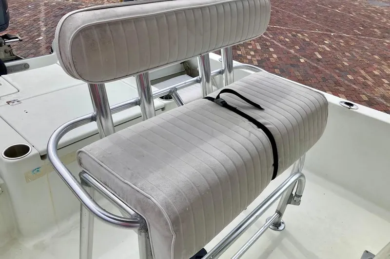 Slide: The Image of White cushioned seat on a 2007 Coastal Bay 2310 boat, featuring metal frame. - 37