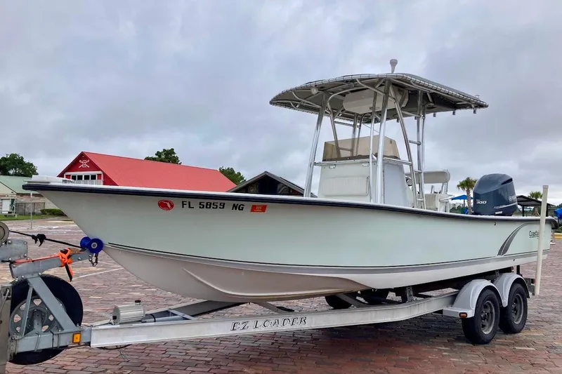 Slide: The Image of 2007 Coastal Bay 2310 boat on trailer, parked outdoors with overcast sky. - 4
