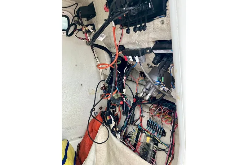 Slide: The Image of Electrical wiring inside a 2007 Coastal Bay 2310 boat, showcasing complex connections. - 41