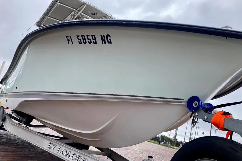 Slide: The Image of 2007 Coastal Bay 2310 boat on trailer, registration FI 5859 NG, overcast sky. - 6