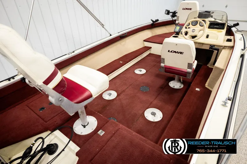 Slide: The Image of 1999 Lowe Sea Nymph V 179 SCX boat interior with red carpet and white seats. - 11