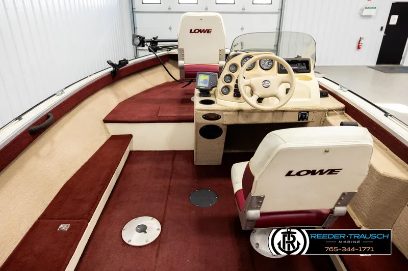 Slide: The Image of 1999 Lowe Sea Nymph V 179 SCX boat interior with red and beige seating. - 13