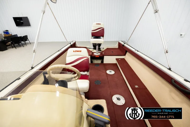 Slide: The Image of 1999 Lowe Sea Nymph V 179 SCX boat interior with red and beige seating. - 16