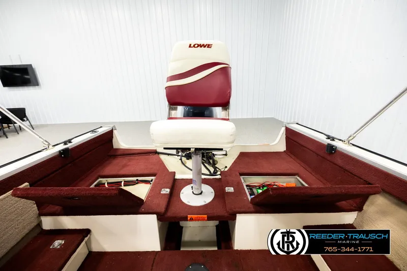 Slide: The Image of 1999 Lowe Sea Nymph V 179 SCX boat interior with red seating and storage compartments. - 19