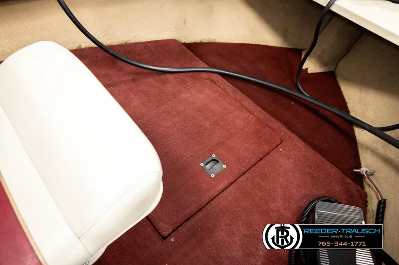 Slide: The Image of Interior of 1999 Lowe Sea Nymph V 179 SCX boat with maroon carpet and white seat. - 24