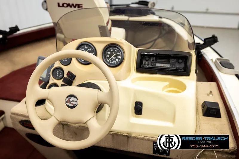 Slide: The Image of 1999 Lowe Sea Nymph V 179 SCX boat dashboard with steering wheel and gauges. - 25