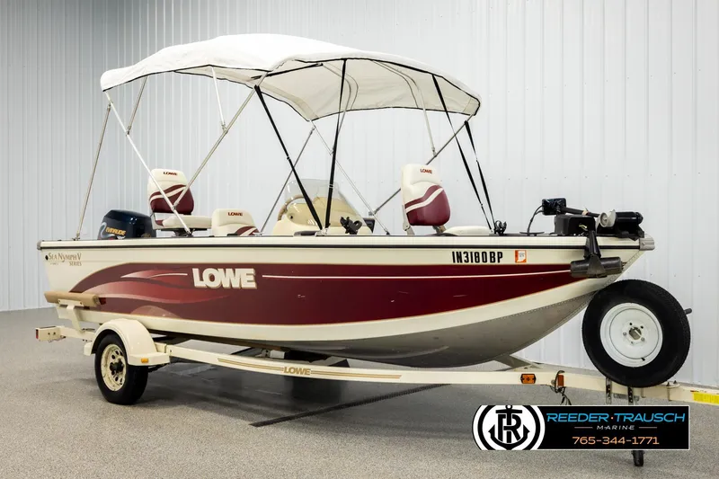 Slide: The Image of 1999 Lowe Sea Nymph V 179 SCX boat with canopy and trailer in showroom. - 3